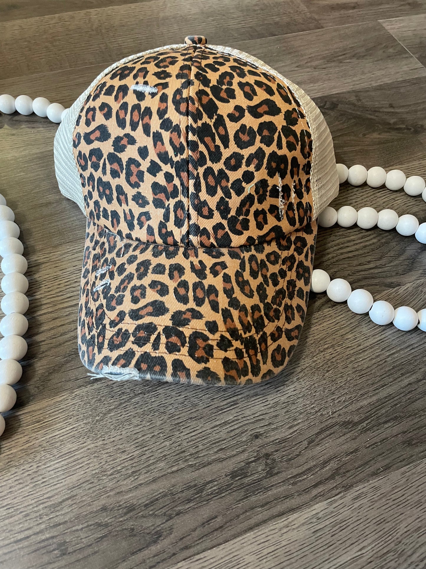 Distressed leopard criss cross hat